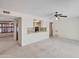 Open-concept living room featuring neutral carpet, access to kitchen, and modern ceiling fan at 8326 E Valley View Rd, Scottsdale, AZ 85250