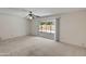 Spacious living room with neutral carpet, sliding glass doors to back patio, and backyard views at 8326 E Valley View Rd, Scottsdale, AZ 85250