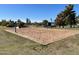 Sand volleyball court with net, surrounded by green grass, inviting residents for recreation and outdoor activities at 8326 E Valley View Rd, Scottsdale, AZ 85250