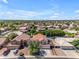 Expansive aerial view of a vibrant neighborhood with tidy homes, beautiful landscaping, and a stunning mountain backdrop at 8931 W Alex Ave, Peoria, AZ 85382