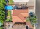 An aerial view captures a home featuring a swimming pool, patio, and meticulously landscaped backyard at 8931 W Alex Ave, Peoria, AZ 85382