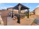Relaxing backyard featuring a hot tub under a gazebo, a grill, and ample patio space at 8931 W Alex Ave, Peoria, AZ 85382