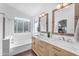 Bathroom showcasing a double vanity with marble countertop, glass shower, and soaking tub at 8931 W Alex Ave, Peoria, AZ 85382
