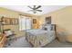 Bright bedroom with a queen bed, a ceiling fan, and a window, perfect for relaxation and rest at 8931 W Alex Ave, Peoria, AZ 85382