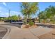 Image displays a community sign with landscaping and surrounding greenery and multiple parked cars at 8931 W Alex Ave, Peoria, AZ 85382