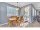Bright dining area features a wood table with seating for six, plus a sliding glass door leading to a patio at 8931 W Alex Ave, Peoria, AZ 85382