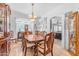 Formal dining room featuring a wood table, chairs, tile floors, and elegant chandelier at 8931 W Alex Ave, Peoria, AZ 85382