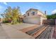 Attractive two-story home showcasing a well-maintained yard, mature landscaping, a large driveway and a 2-car garage at 8931 W Alex Ave, Peoria, AZ 85382