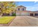 Charming two-story home featuring a spacious driveway, lush green lawn, mature landscaping, and a 2-car garage at 8931 W Alex Ave, Peoria, AZ 85382
