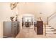 Elegant foyer featuring high ceilings, a staircase, and a view into the dining area at 8931 W Alex Ave, Peoria, AZ 85382