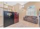 Bright foyer featuring high ceilings, staircase, modern sofa, and views of the main living areas at 8931 W Alex Ave, Peoria, AZ 85382