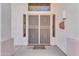 Inviting front door with ornate security gate, a decorative welcome mat, and charming welcome sign at 8931 W Alex Ave, Peoria, AZ 85382