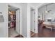 Hallway with closet leads to the primary bedroom featuring a fireplace and large windows for natural light at 8931 W Alex Ave, Peoria, AZ 85382