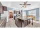 Kitchen with center island, granite countertops, dark cabinetry, and stainless appliances at 8931 W Alex Ave, Peoria, AZ 85382