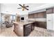 Modern kitchen features a large island with granite countertops, dark cabinets, and stainless steel appliances at 8931 W Alex Ave, Peoria, AZ 85382