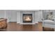 Living room featuring a fireplace and hardwood floors with a cushioned chair at 8931 W Alex Ave, Peoria, AZ 85382