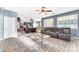 Open-concept living room featuring tile floors, a comfortable seating area, and seamless flow to the kitchen at 8931 W Alex Ave, Peoria, AZ 85382