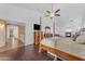 Bright primary bedroom with four-poster bed, hardwood floors, ceiling fan, and fireplace at 8931 W Alex Ave, Peoria, AZ 85382