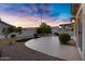 Landscaped backyard featuring a patio, desert rock accents, and privacy walls in a residential neighborhood at 896 N Kingston St, Gilbert, AZ 85233