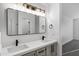 Bathroom with a double vanity, modern lighting, and a sleek rectangular mirror at 896 N Kingston St, Gilbert, AZ 85233