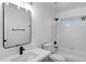 Bright bathroom with a black-trimmed mirror, white vanity, and shower-over-tub at 896 N Kingston St, Gilbert, AZ 85233
