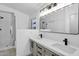 Bathroom featuring a glass-enclosed shower, double vanity, and modern lighting at 896 N Kingston St, Gilbert, AZ 85233