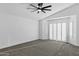 Spacious bedroom featuring a ceiling fan, neutral carpet, and shuttered windows at 896 N Kingston St, Gilbert, AZ 85233