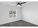 Bedroom with a ceiling fan, window and carpet flooring at 896 N Kingston St, Gilbert, AZ 85233