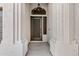 A stylish front door set between decorative white columns under an elegant light fixture at 896 N Kingston St, Gilbert, AZ 85233