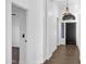 Long hallway featuring hardwood floors, fresh paint, with the front door visible at the end at 896 N Kingston St, Gilbert, AZ 85233