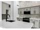 Bright kitchen with white quartz countertops, tiled backsplash, and stainless appliances at 896 N Kingston St, Gilbert, AZ 85233