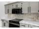 Close up of the modern kitchen featuring gray cabinets and stainless appliances at 896 N Kingston St, Gilbert, AZ 85233