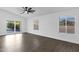 Bright living room featuring sliding glass doors, tile flooring, and large windows for natural lighting at 896 N Kingston St, Gilbert, AZ 85233