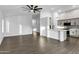 Bright living room with tile floors and ceiling fan open to a modern kitchen at 896 N Kingston St, Gilbert, AZ 85233