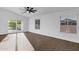 Bright living room with hardwood floors and large windows, offering plenty of natural light and space at 896 N Kingston St, Gilbert, AZ 85233