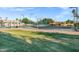 Exterior view of a community tennis and basketball court, surrounded by green grass and landscaping at 896 N Kingston St, Gilbert, AZ 85233