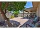 Backyard featuring a patio, decorative wall, and lush landscaping at 10648 W Loma Blanca Dr, Sun City, AZ 85351