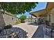 Backyard featuring a patio, decorative wall, and lush landscaping at 10648 W Loma Blanca Dr, Sun City, AZ 85351