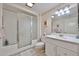 Clean bathroom featuring a shower, toilet, and a vanity with storage space at 10648 W Loma Blanca Dr, Sun City, AZ 85351