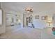 Bright bedroom features mirrored closet doors and ceiling fan at 10648 W Loma Blanca Dr, Sun City, AZ 85351
