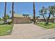 Attractive home featuring a two car garage, desert landscaping, and mature trees at 10648 W Loma Blanca Dr, Sun City, AZ 85351