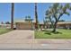Charming single-story home with a two car garage, desert landscaping, and lush green lawn at 10648 W Loma Blanca Dr, Sun City, AZ 85351