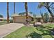 Charming single-story home with desert landscaping, mature trees, and a two-car garage at 10648 W Loma Blanca Dr, Sun City, AZ 85351