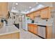 Spacious kitchen with light wood cabinets, modern appliances, and tile flooring at 10648 W Loma Blanca Dr, Sun City, AZ 85351