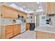 Functional kitchen with light wood cabinets, modern appliances, and ample counter space at 10648 W Loma Blanca Dr, Sun City, AZ 85351