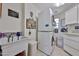 Well-organized laundry room featuring a stacked washer/dryer and a sink with storage space at 10648 W Loma Blanca Dr, Sun City, AZ 85351