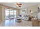 Bright living room with sliding glass doors to the patio, and modern decor at 10648 W Loma Blanca Dr, Sun City, AZ 85351