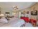 Spacious bedroom featuring a ceiling fan, natural light, and warm decor at 10648 W Loma Blanca Dr, Sun City, AZ 85351