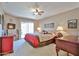 Cozy main bedroom with soft lighting, a ceiling fan, and private patio access at 10648 W Loma Blanca Dr, Sun City, AZ 85351