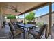Covered patio with seating and well-maintained landscaping at 10648 W Loma Blanca Dr, Sun City, AZ 85351